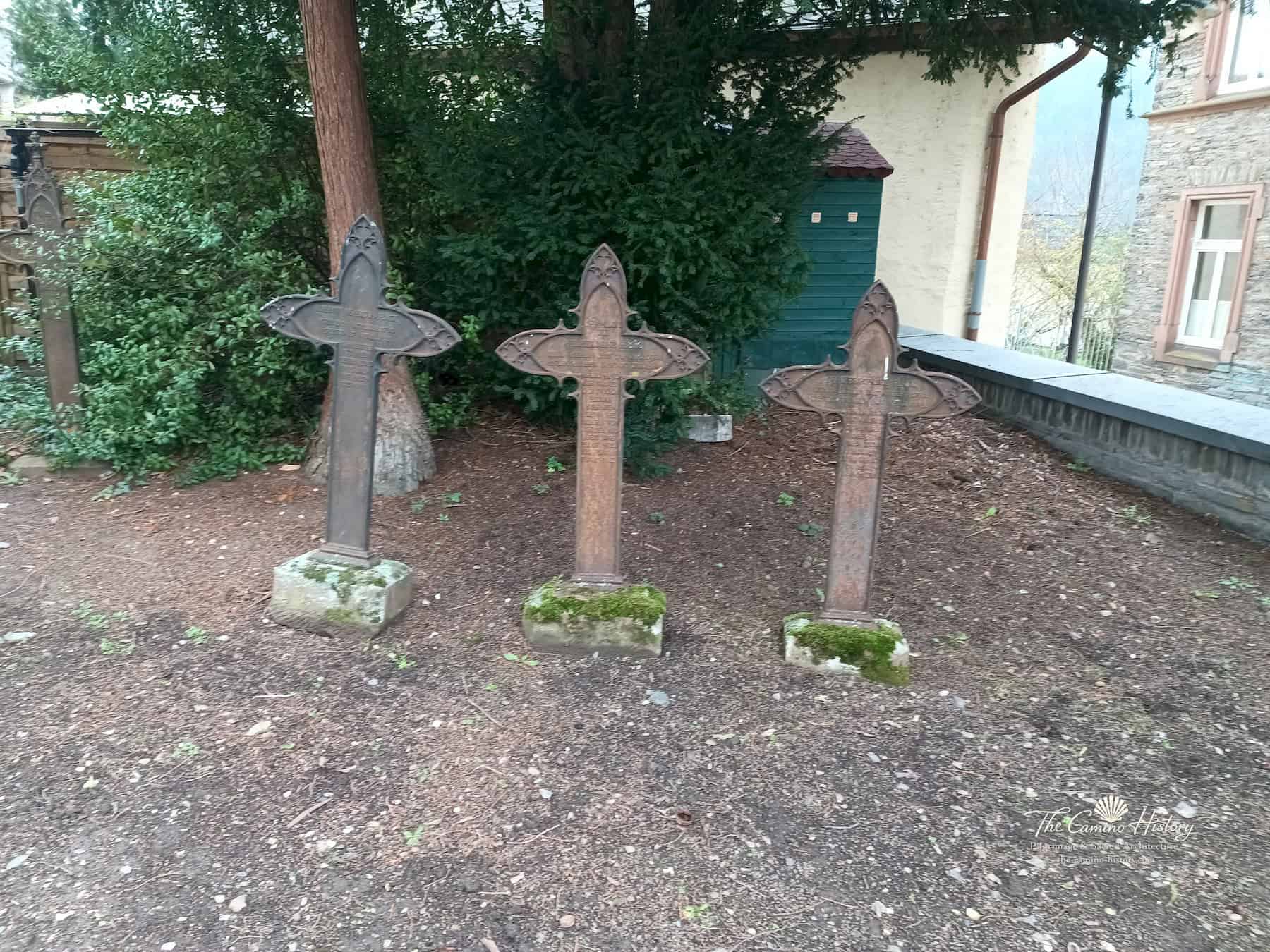 Drei historische gusseiserne Grabkreuze mit gotisierenden Formen auf dem Kirchhof der Peterskirche
