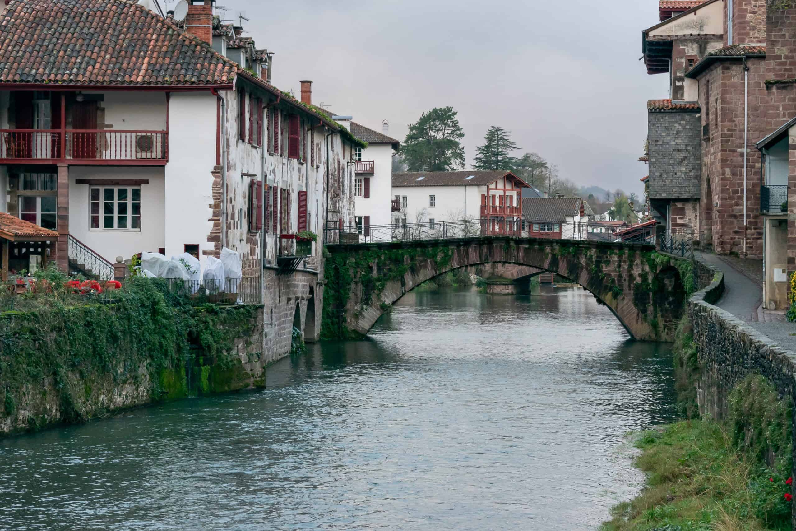 Steinerne Bogenbrücke über die Nive mit historischen Häusern in Saint-Jean-Pied-de-Port